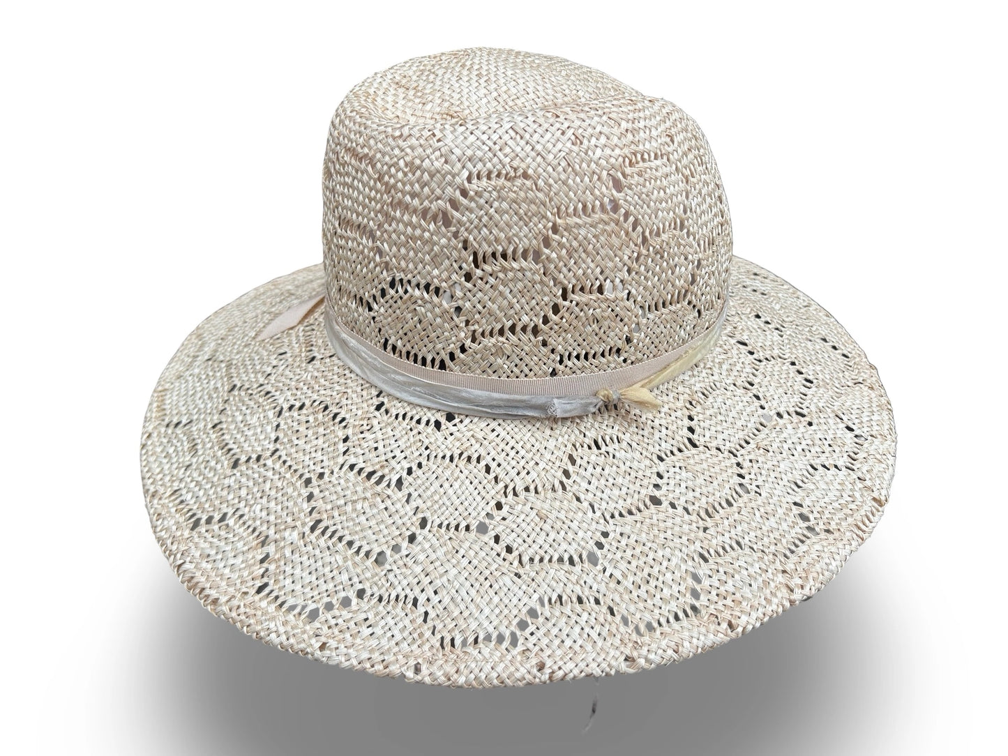 Beige woven sun hat with a wide brim on a white background