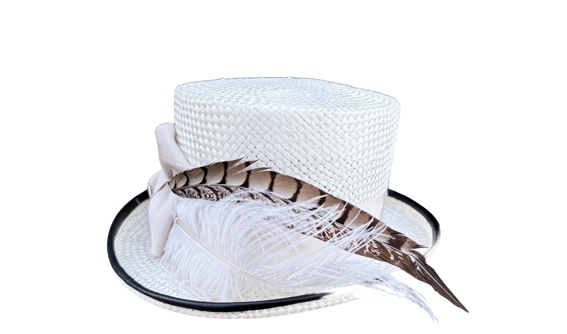 White woven hat with black piping and feathers on a white background