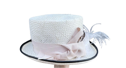 White woven hat with a decorative bow and feather on a white background, right view