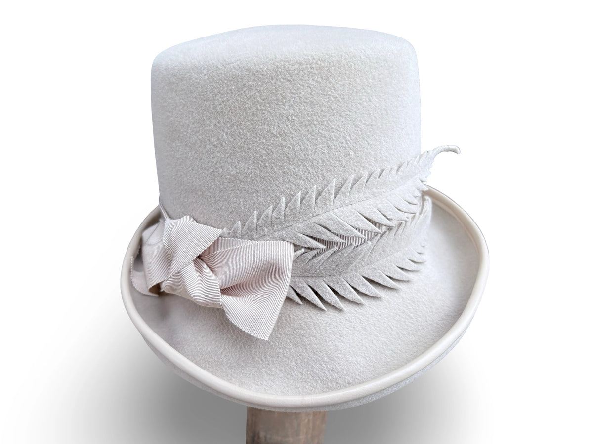 Alabaster Cloche Bucket Hybrid hat with matching piping and Grosgrain trim. Hand made felt feathers.
