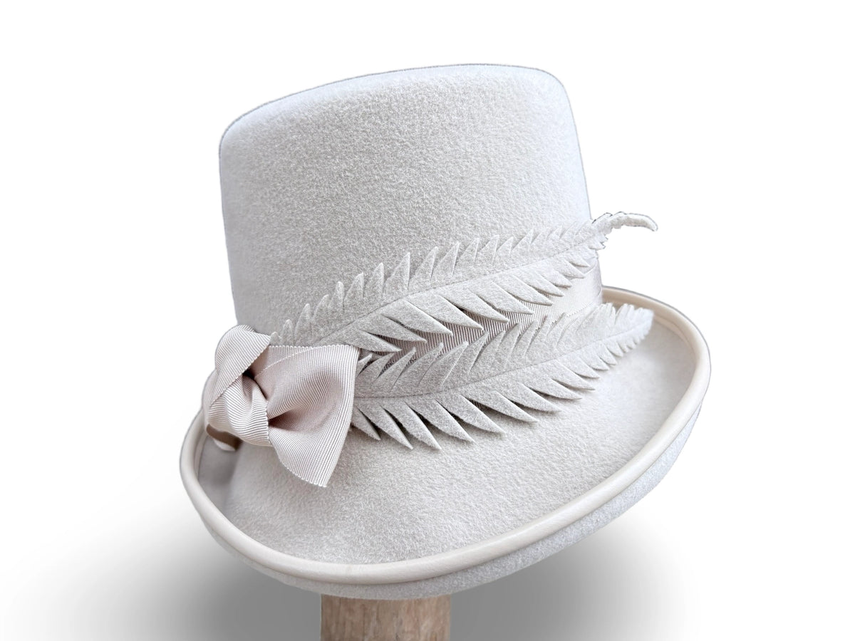 Alabaster Cloche Bucket Hybrid hat with matching piping and Grosgrain trim. Hand made felt feathers.
