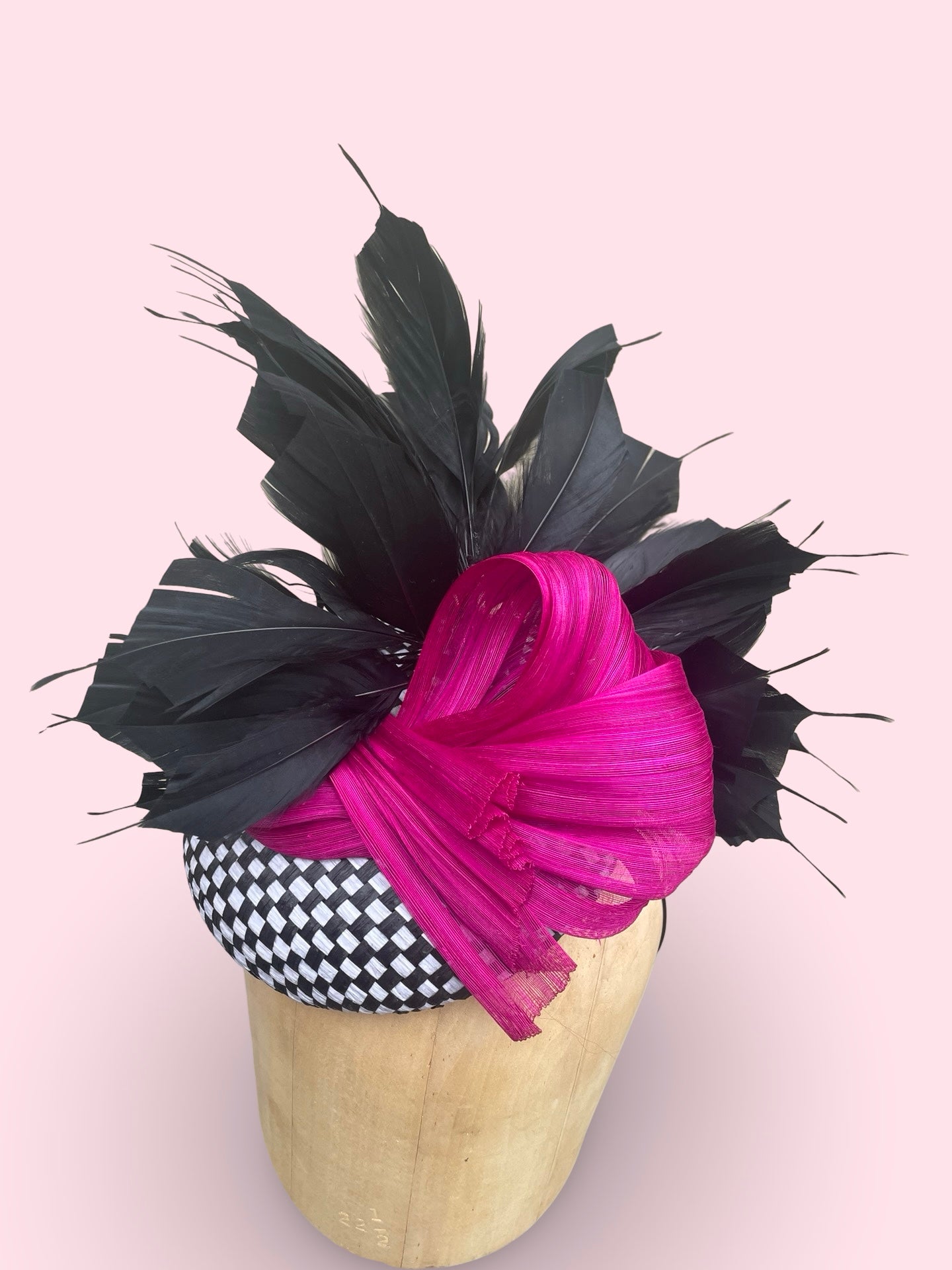 Black and white check straw pillbox with black feather spray and fuschia silk Abaca bow