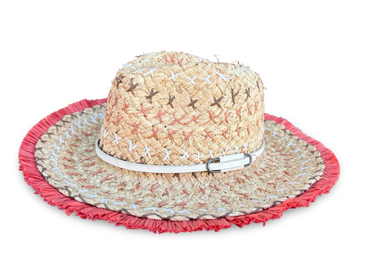 A woven straw sun hat with a wide brim, featuring a red fringed edge, a white band with a silver buckle, and small embroidered details on the crown, shown against a plain white background.