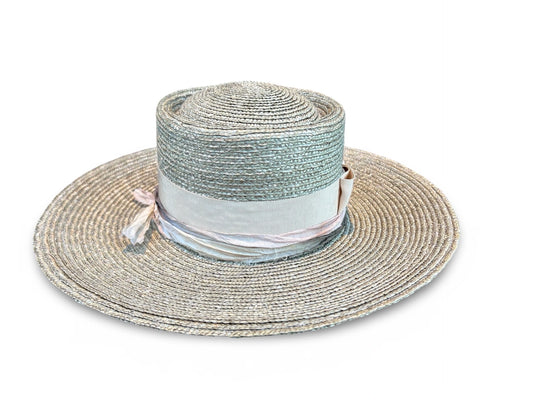 Wide-brimmed straw hat with a ribbon on a white background