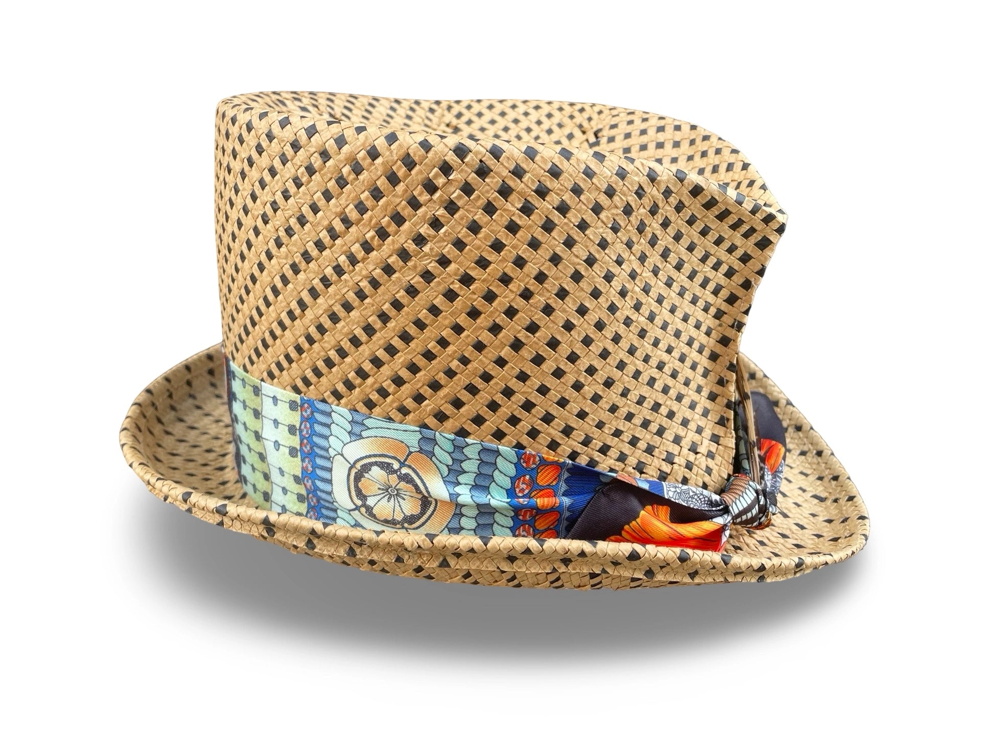 Woven straw top hat with a colorful twilly on a white background