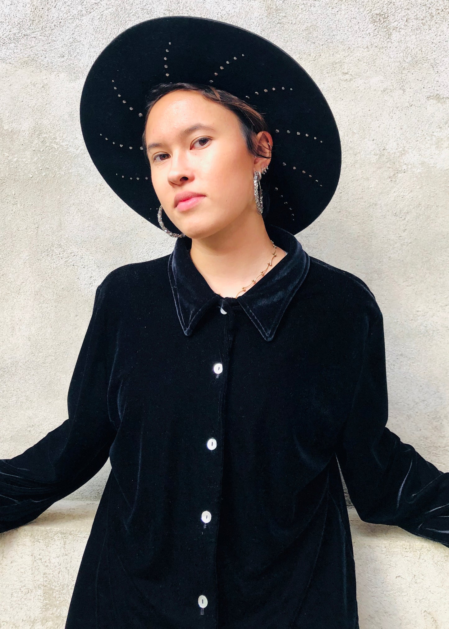 Black wool felt fedora with suede cord trim. Under-brim features a unique halo stud design.