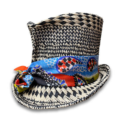 Black and Ivory graphic pattern straw top hat with silk scarf trim and pheasant tail feather.