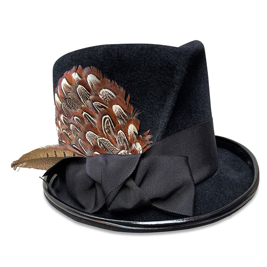 A stylish, black top hat with a shorter silhouette, featuring a pleated detail around the base, black patent leather piping, and trimmed with a wide grosgrain ribbon. It's accented with a cluster of natural-toned feathers tucked into the ribbon on the side.