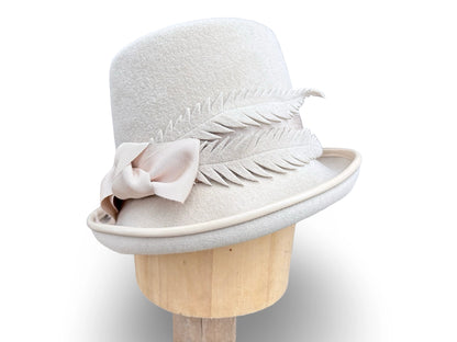 Alabaster Cloche Bucket Hybrid hat with matching piping and Grosgrain trim. Hand made felt feathers.
