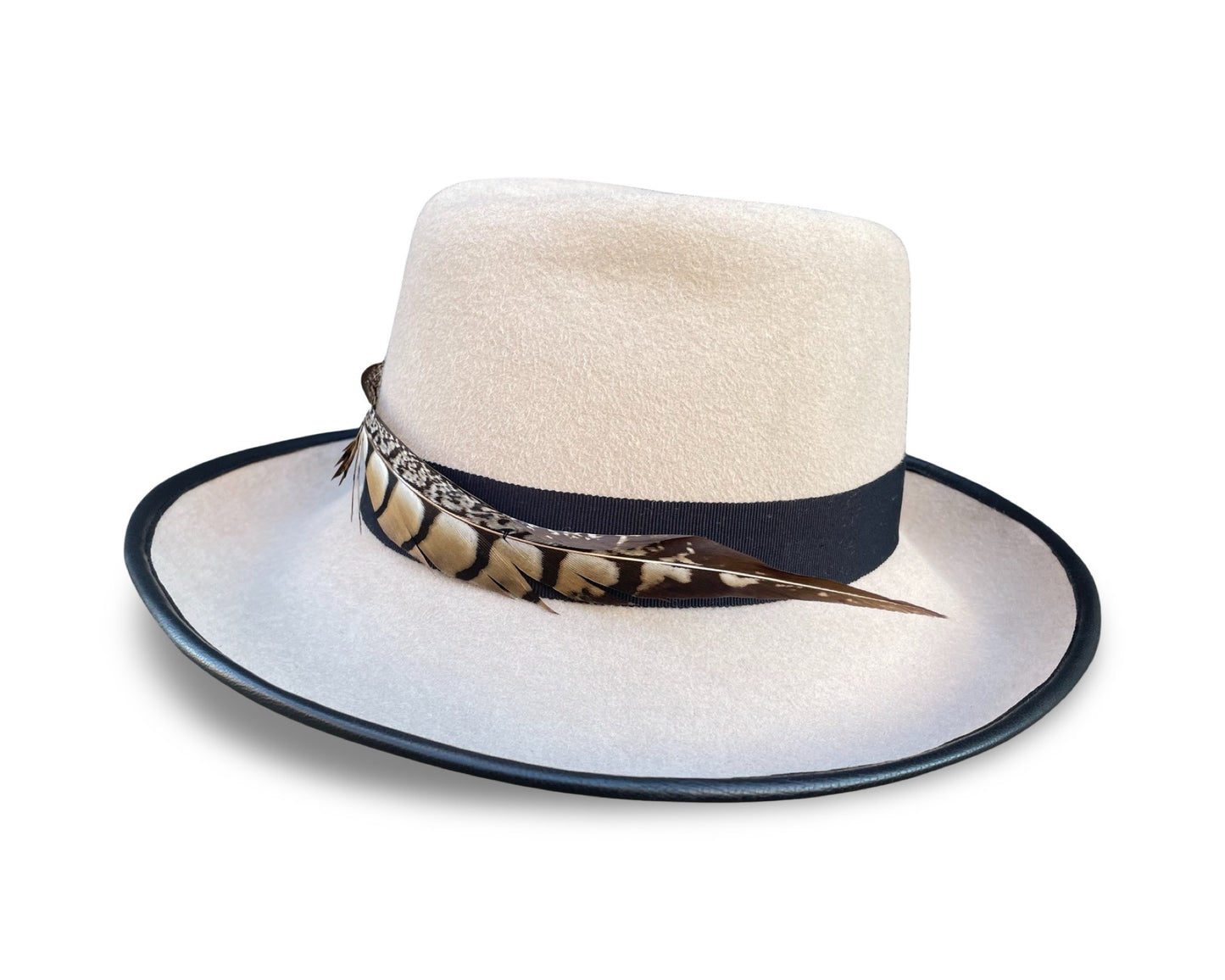 Alabaster Fedora trimmed with black grosgrain and pheasant tail. Brim is piped with black lamb skin
