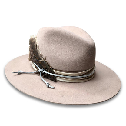 Biege Wool Western Style Fedora with silk trim and suede cord. Three inch brim, right side view. with a turkey feather