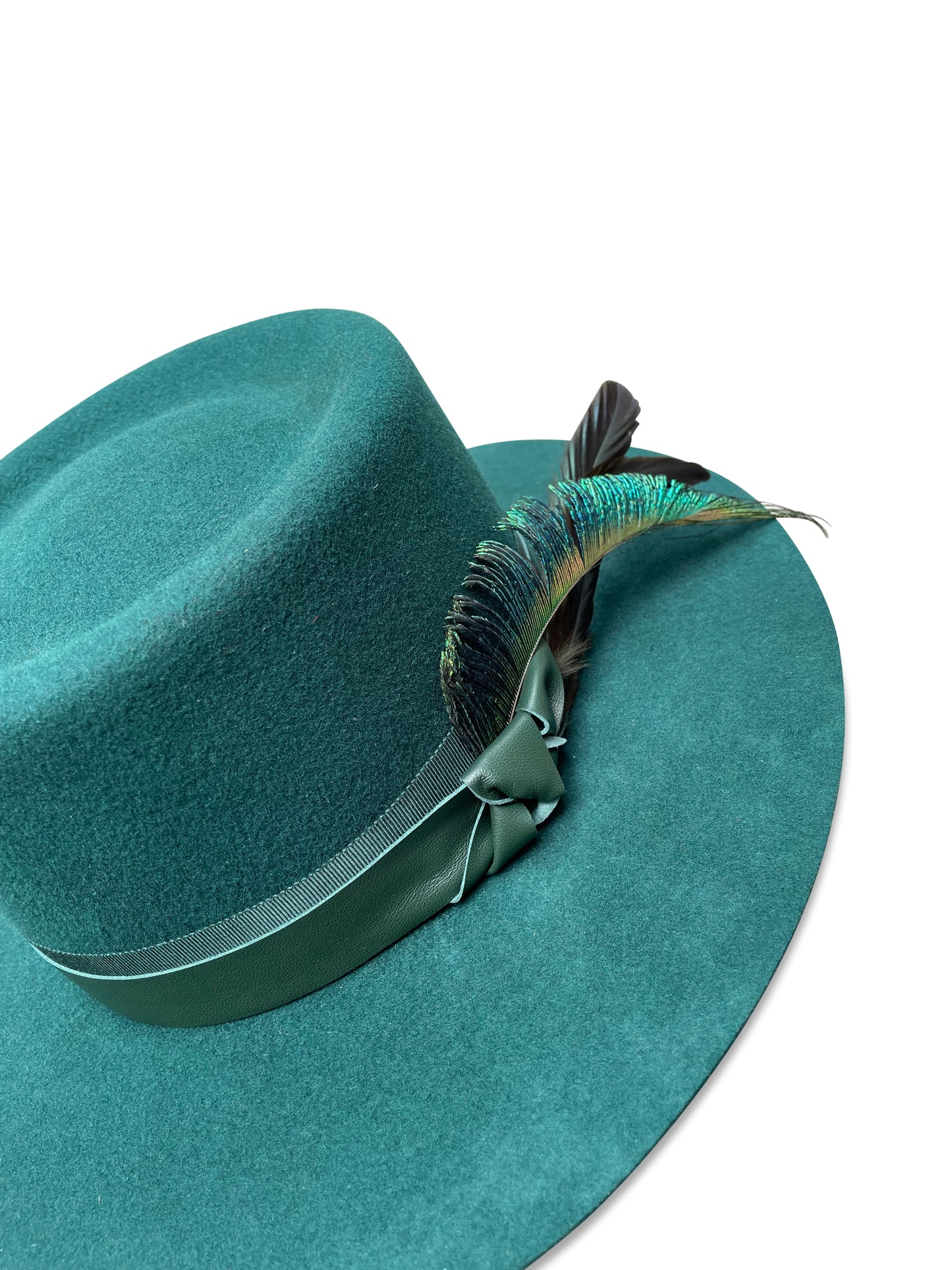 Green gambler-style wool felt hat with grosgrain and lambskin trim, featuring a peacock sword feather, from Cha Cha's House of Ill Repute