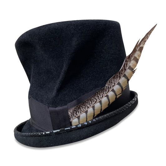 handcrafted top hat named 'Grimm', made by Cha Cha's House of Ill Repute, a millinery based in New York City. The hat features a black velour finish with fur felt texture, accentuated by a black grosgrain ribbon with hand embroidery and a brim outlined with faux lizard leather piping. A natural pheasant tail feather adds a distinguished touch to the hat, which exudes a vintage, Dickensian character.