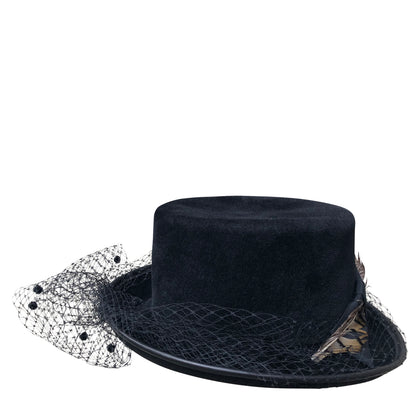 coachman-style hat is adorned with a whimsical dotted veiling that falls gently over the eyes, hinting at a bygone era of mystery and romance. 